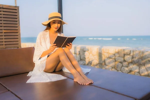 Portrait young asian woman read book around beach sea ocean — Stock Photo, Image