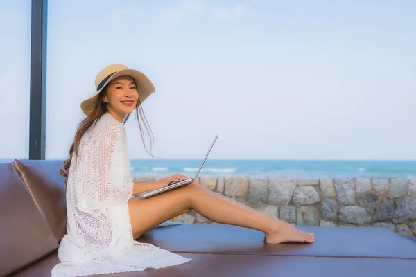 Portrait young asian woman using laptop computer around beach se — Stock Photo, Image