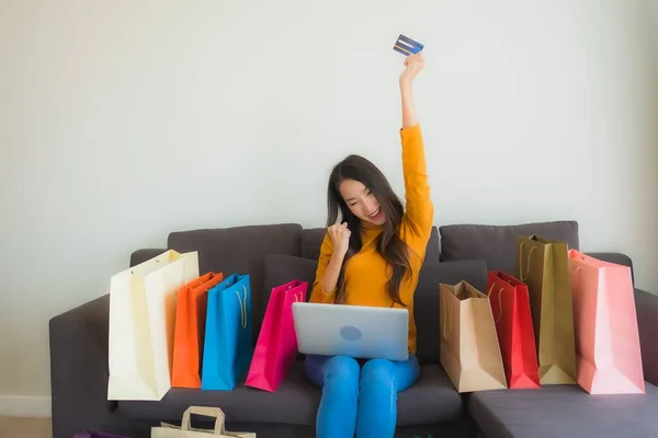 Portrait young asian woman using laptop computer with smart mobi — Stock Photo, Image