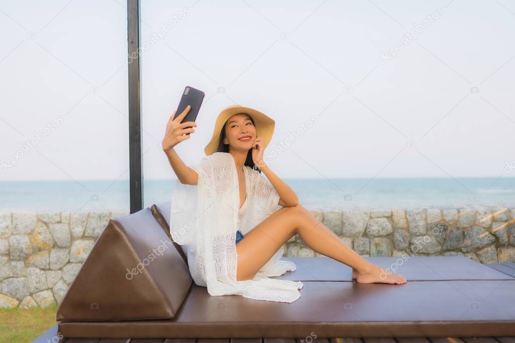 Portrait young asian woman using smart mobile phone around outdo