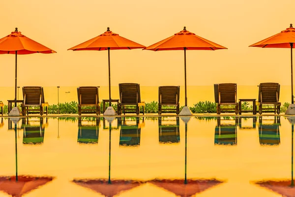 Beautiful sunrise around with umbrella and chair outdoor swimmin — 스톡 사진