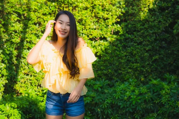 Portrait young asian woman happy smile relax around outdoor natu