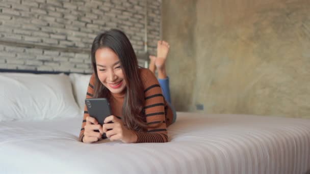 집에서 스마트폰을 사용하는 아름다운 이시아 여성의 — 비디오