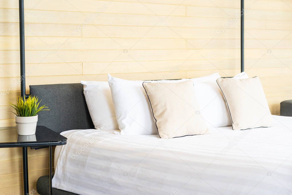 White comfortable pillow on bed decoration interior of bed room in hotel resort