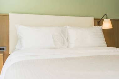 Yatak odasının iç dekorasyonunda beyaz rahat yastık.