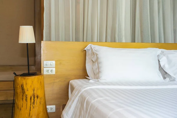 Pillow and blanket on bed with light lamp decoration interior of bedroom