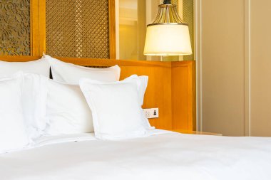 Yatak odasının iç tarafındaki yatak dekorasyonunda rahat beyaz yastık.