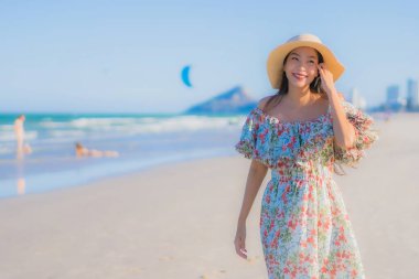 Güzel bir Asyalı kadın portresi. Mutlu bir gülümseme. Mavi gökyüzündeki tropikal deniz okyanusunda rahatla.