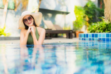 Güzel bir Asyalı kadın portresi. Tatilde dinlenmek için otel havuzunda dinleniyor.