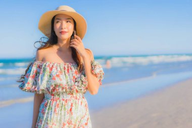 Güzel bir Asyalı kadın portresi. Mutlu bir gülümseme. Mavi gökyüzündeki tropikal deniz okyanusunda rahatla.