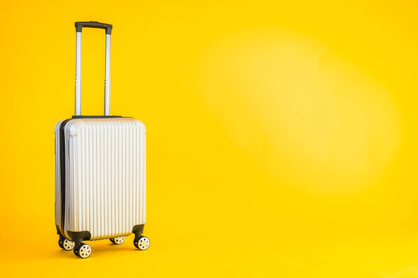 Gray color luggage or baggage bag use for transportation travel and leisure on yellow isolated background