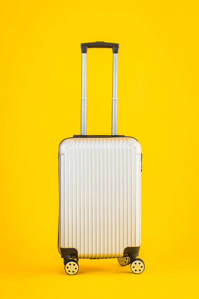 Gray color luggage or baggage bag use for transportation travel and leisure on yellow isolated background
