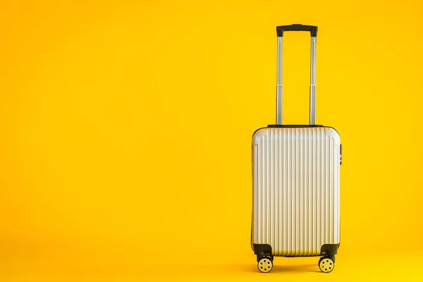 Gray color luggage or baggage bag use for transportation travel and leisure on yellow isolated background