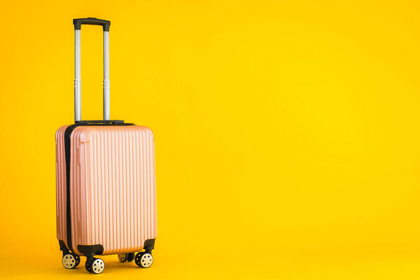 Pink color luggage or baggage bag use for transportation travel and leisure on yellow isolated background