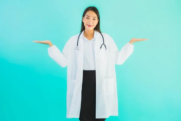 Portrait beautiful young asian doctor asian woman work at clinic or hospital on blue isolated background