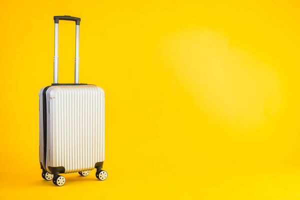 Gray color luggage or baggage bag use for transportation travel and leisure on yellow isolated background