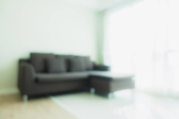 Abstract blur and defocus sofa decoration in living room interior for background