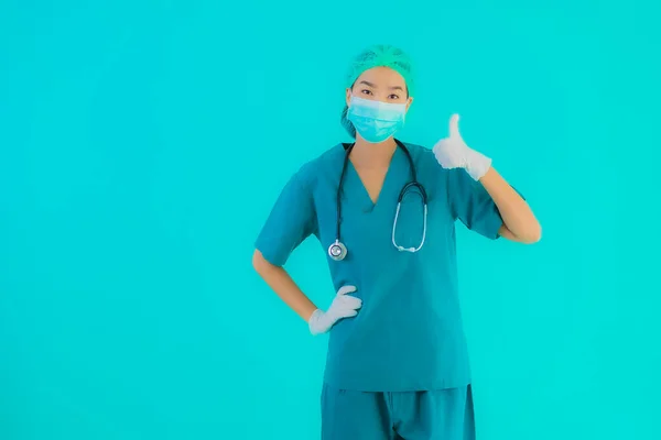 Portrait beautiful young asian doctor woman with mask and eyeglassses for protect from covid19 or coronavirus on blue isolated background