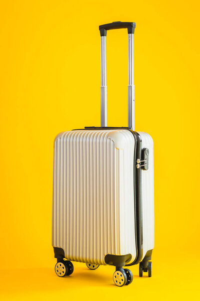 Gray color luggage or baggage bag use for transportation travel and leisure on yellow isolated background