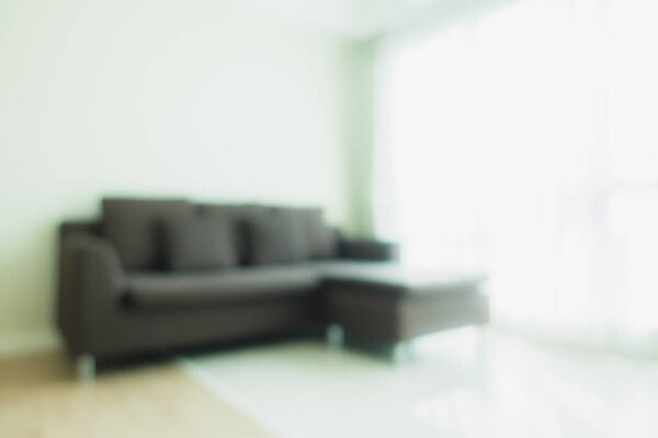 Abstract blur and defocus sofa decoration in living room interior for background
