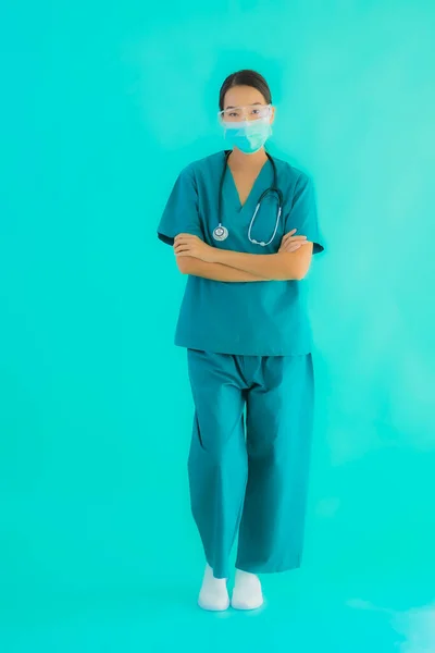 Portrait beautiful young asian doctor woman with mask and eyeglassses for protect from covid19 or coronavirus on blue isolated background