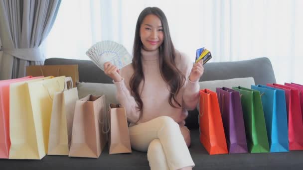 Footage Beautiful Young Asian Woman Holding Money While Sitting Couch — Stock Video