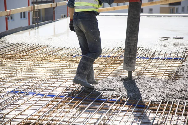 Constrution site - worker leaving conctere from automatic pump