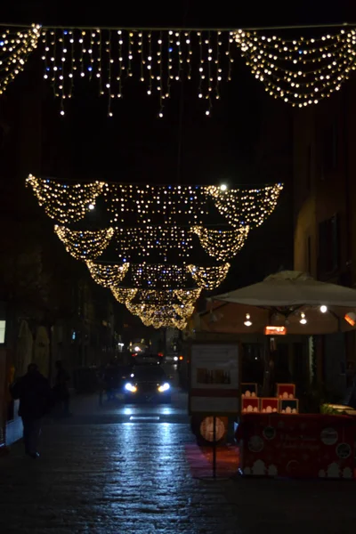 Aralık 2019, Bologna, İtalya - Bolonya şehir sokakları, Noel ışıkları, şehir dekorasyonları, kemerler, arabalar