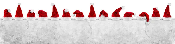 Reihe Roter Weißer Plüsch Weihnachtsmann Weihnachtsmütze Auf Leerer Betonwand Werbetafel — Stockfoto