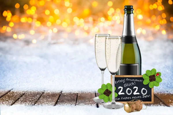 Bottle of champagne with glasses cork and blackboard german gree — Stock Photo, Image