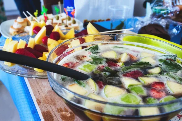 Punch bowl with pieces of fruit at a party
