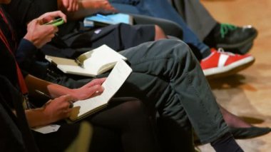 Konferansta notlar alarak kalabalık