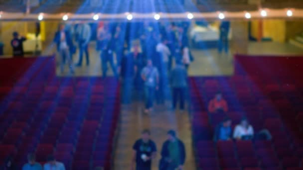 People Walking in the Cinema Below Projectors Rays — Stock Video