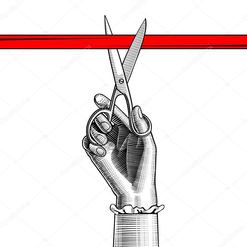 Woman's hand with scissors cutting red ribbon