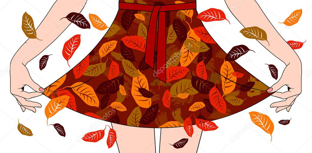 Woman's hands pull the edge of the dress with autumn fall decora