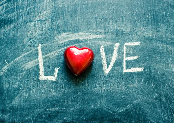Word love on a chalkboard/toned photo — Stock Photo, Image
