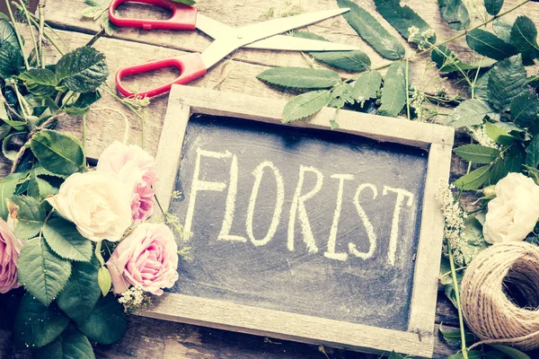 Florist workspace with flowers on background,close up