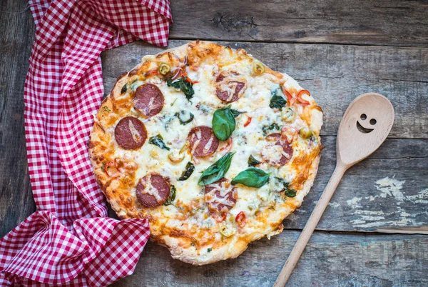 Pizza pepperoni on a wooden background — Stock Photo, Image