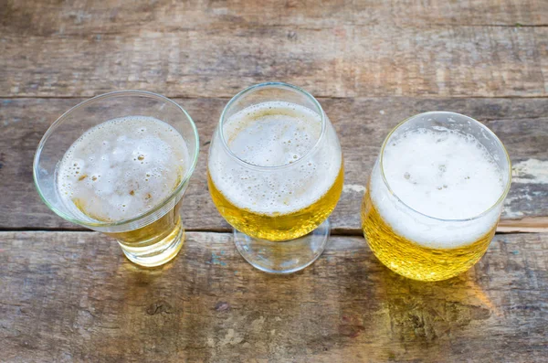 Beer in glasses on a wooden background — Stock Photo, Image