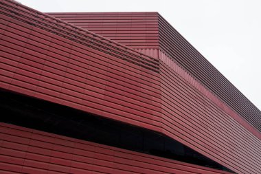 Red metal facade design of modern building