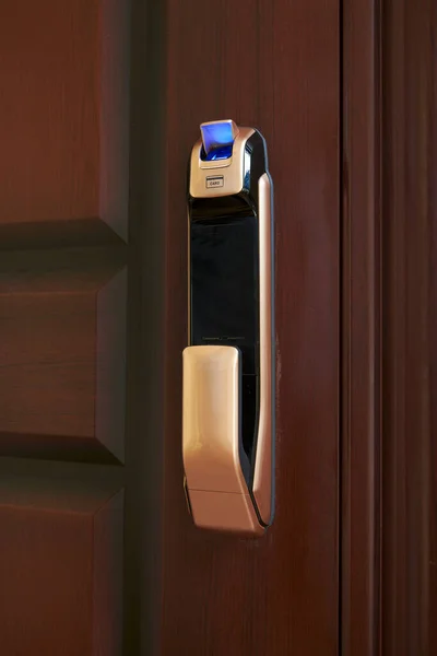 Close-up of a smart door lock with fingerprint area open