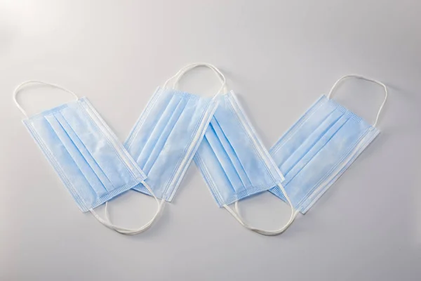 Letter W placed with disposable medical surgical mask