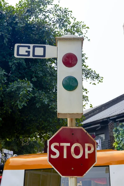 A vintage traffic light and stop sign