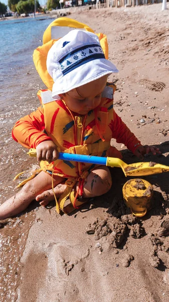 Chłopiec Bawiący Się Łopatą Piaszczystej Plaży — Zdjęcie stockowe