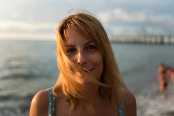 Portrait of a woman at sunset by the sea