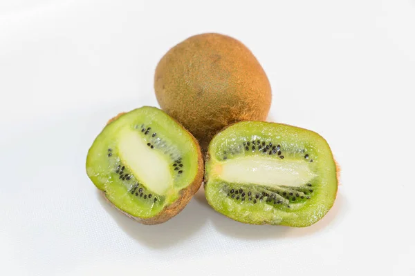 Frutos maduros de kiwi enteros y medio kiwi aislados sobre fondo blanco — Foto de Stock