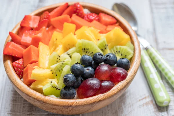 Breakfast oatmeal for kids topped with rainbow fruits — Stock Photo, Image