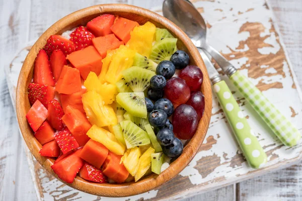 Breakfast oatmeal for kids topped with rainbow fruits