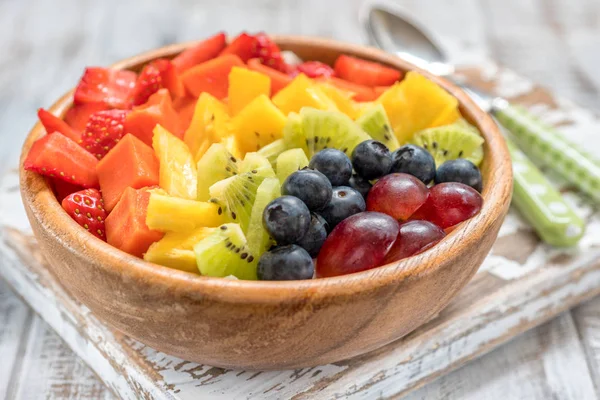 Breakfast oatmeal for kids topped with rainbow fruits — Stock Photo, Image