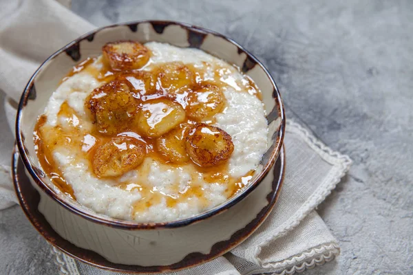 Bowl of oatmeal porridge with banana and honey — Stock Photo, Image